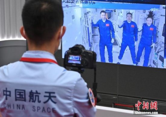 资料图：北京航天飞行控制中心屏幕显示航天员乘组报告进入天和核心舱的画面。 中新社记者 侯宇 摄
